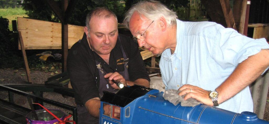 Pete Waterman working on a model train